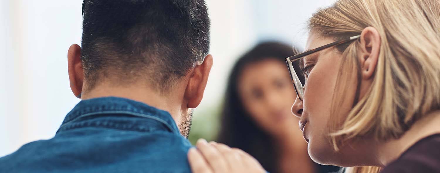 Woman comforting a man